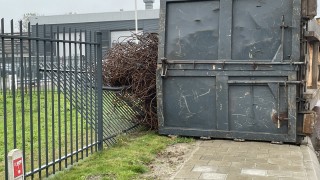 Container met oud ijzer valt van vrachtwagen in Vriezenveen